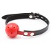 Дышащий кляп-шар красного цвета на черно-красном ремне